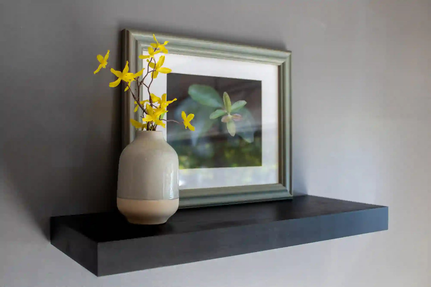 Black heavy duty floating shelves with flower