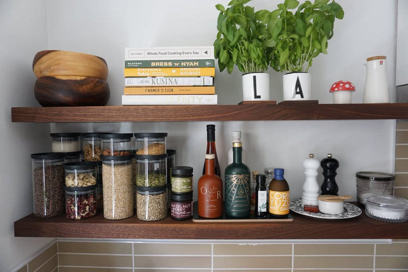 Walnut floating shelves with spices and cookbooks