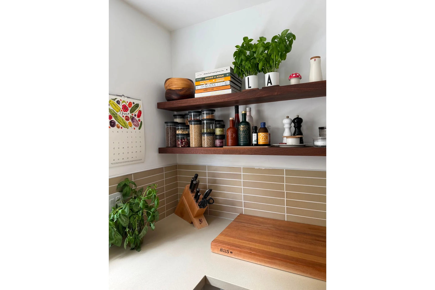 Walnut shelves in kitchen with spices and cook books
