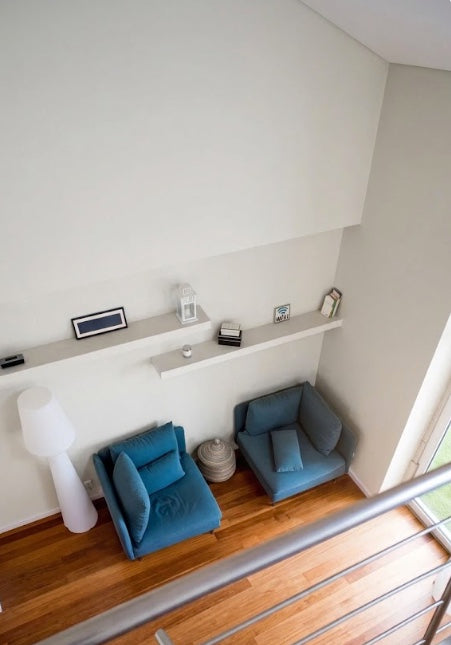 Floating shelves above chairs